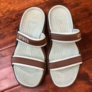 Light blue and brown crocs. Size 8